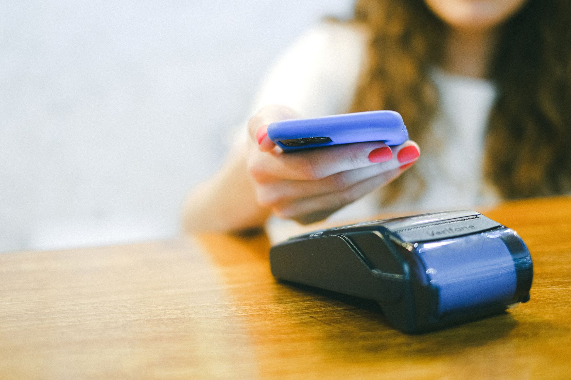 a woman paying using her smartphone